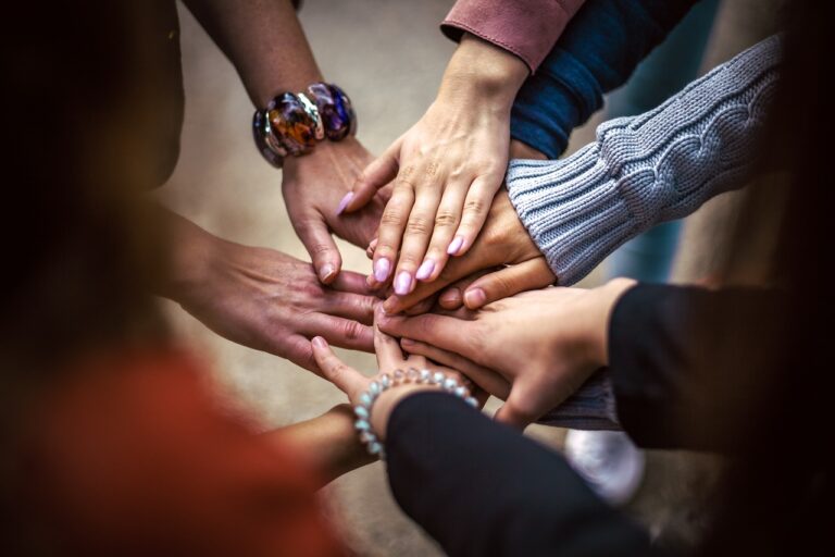 Nine Hands in a huddle